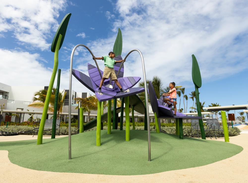 kids climbing on giant flowers at flamingo playground