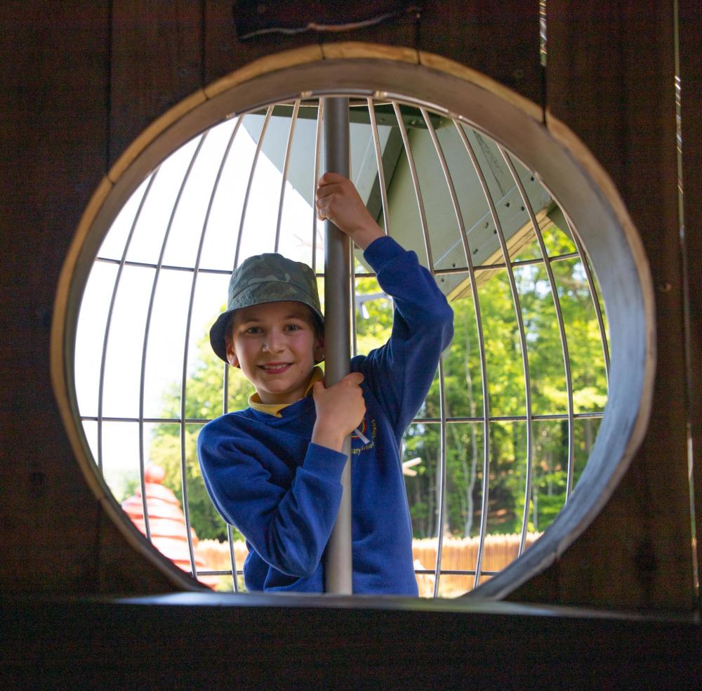 Boy playing inside huge bauble at Lilidorei