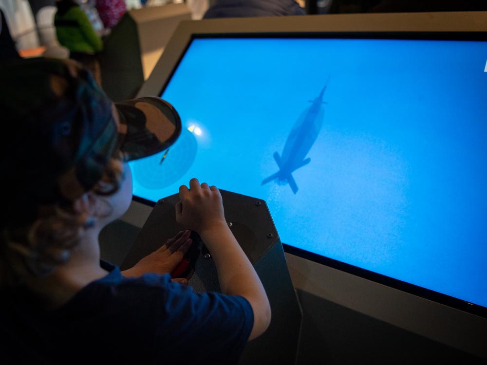 Kid controlling virtual submarine at playground