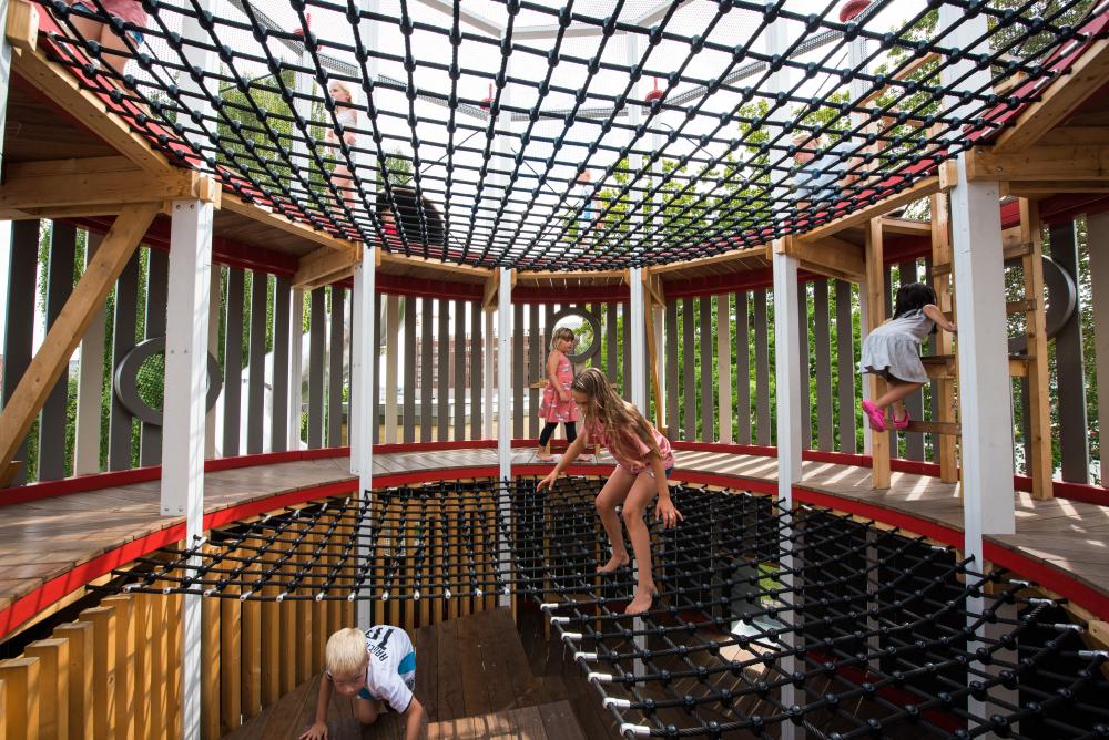 Kids balancing and climbing on rope net, MONSTRUM playground