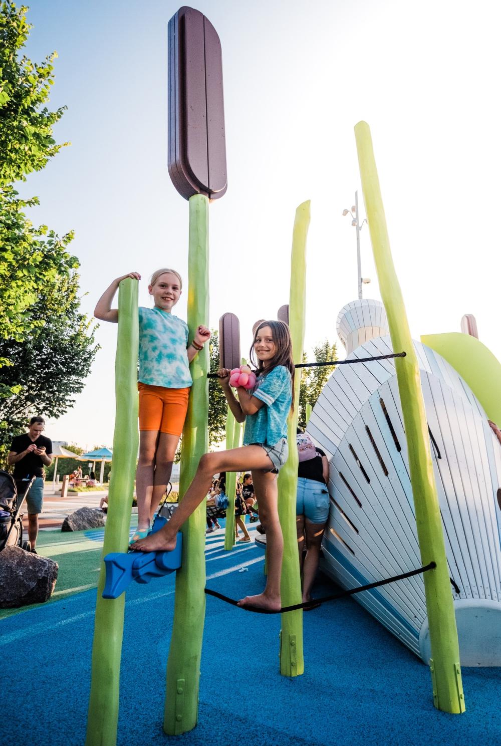 Kids climbing wooden trunks at playground