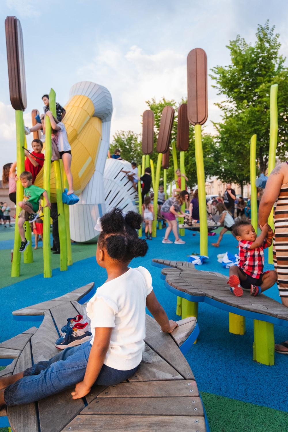 Kids playing on bouncy fish at Pelican playground