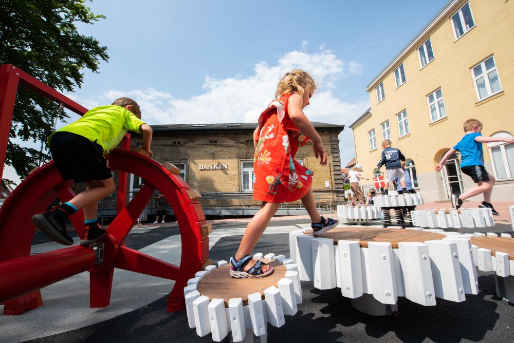 kids playing at playground, jumping on wobble boards