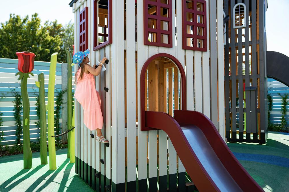 Girl climbing up playground tower