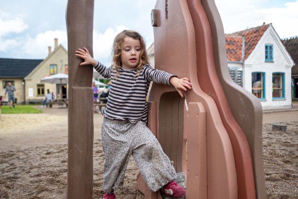 Girl climbing on playground trees