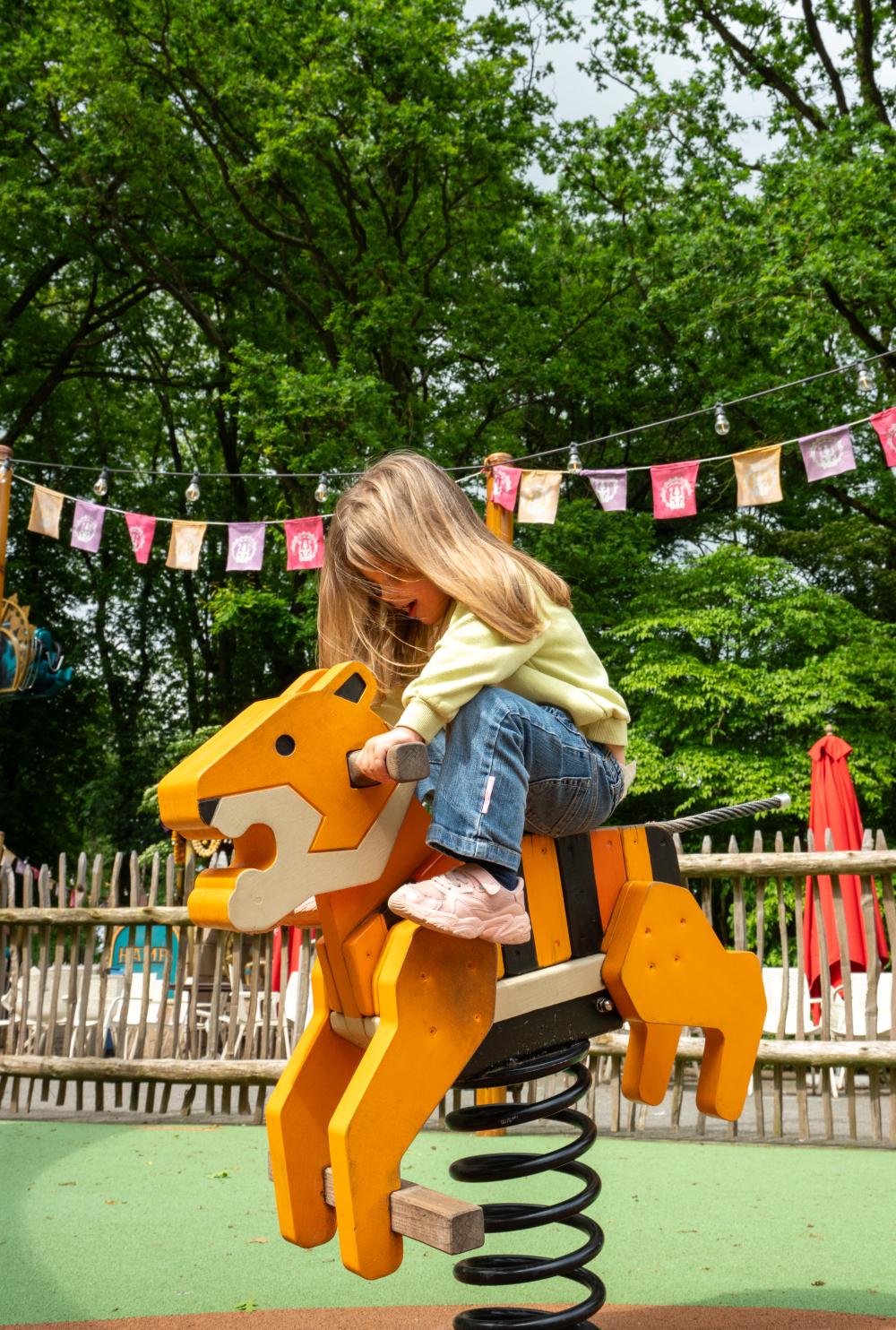 Girl having fun on playground bouncer