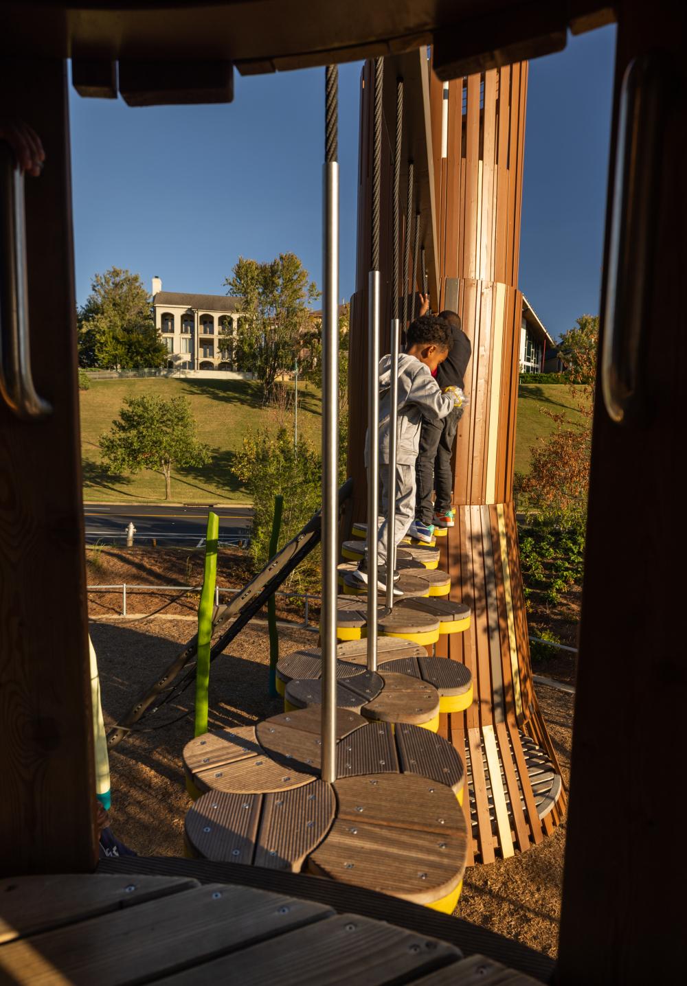 Kids playing up high on tree playground structures