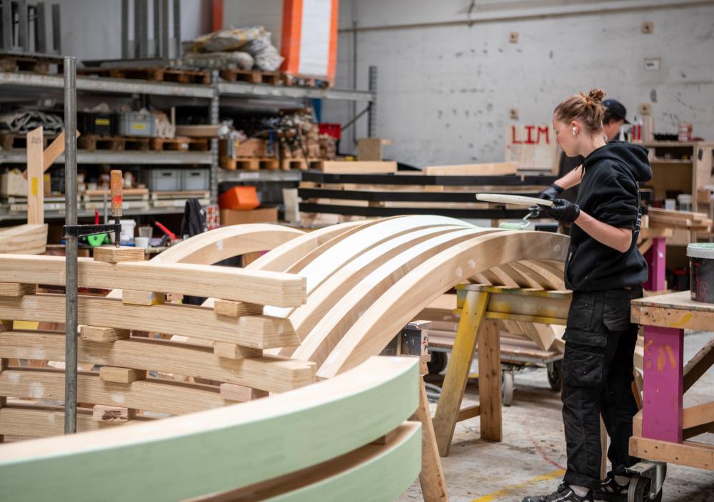 Craftswoman painting wooden playground structure