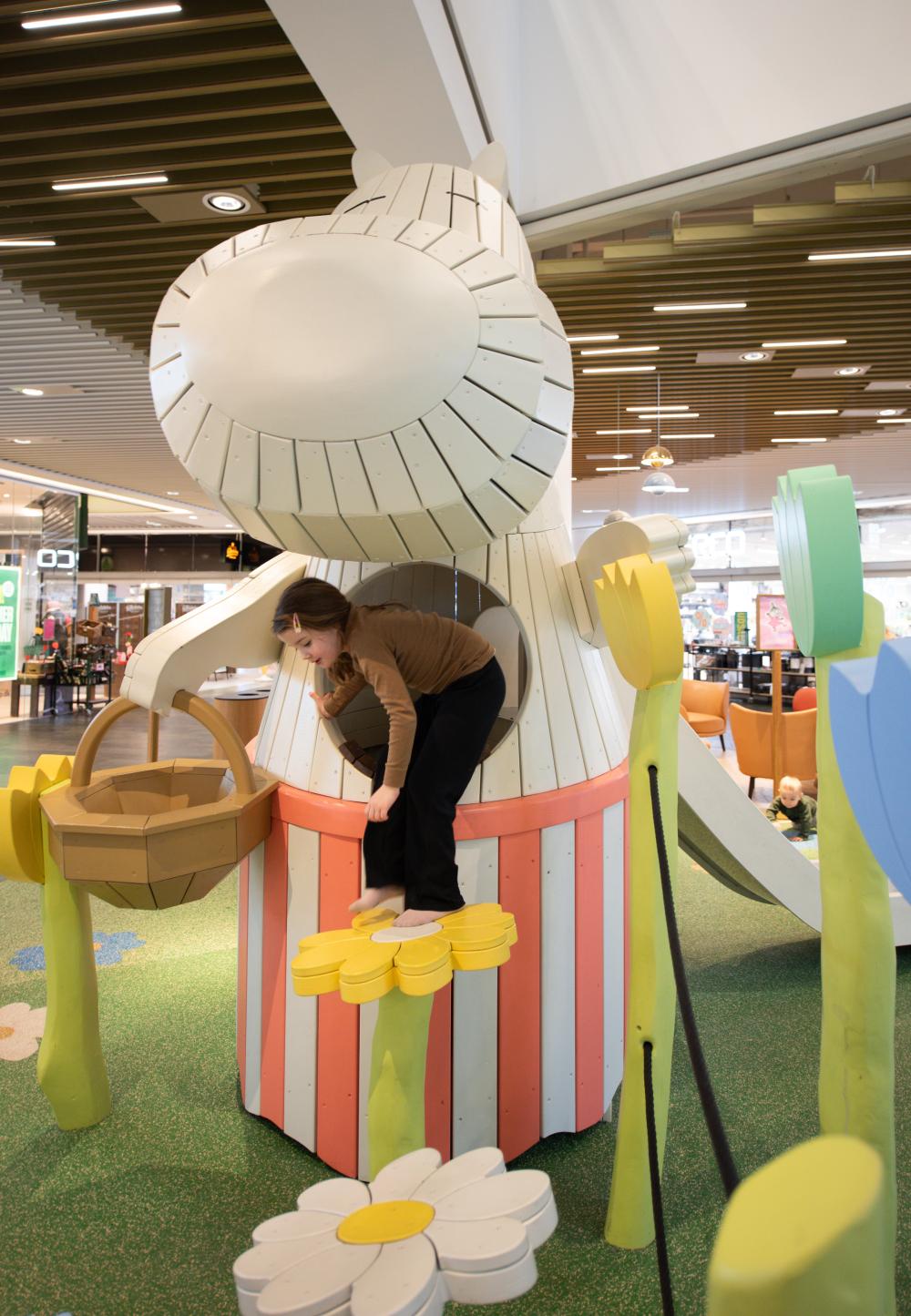girl climbing on Moomin playground structure