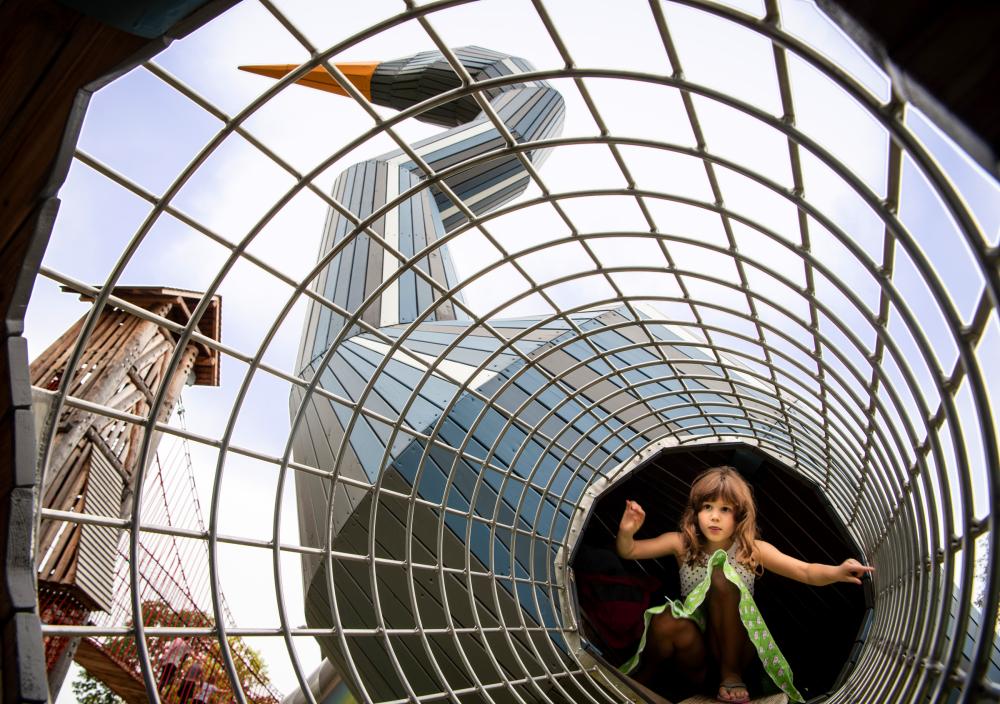 girl climbing in playground tunnel at heron playground